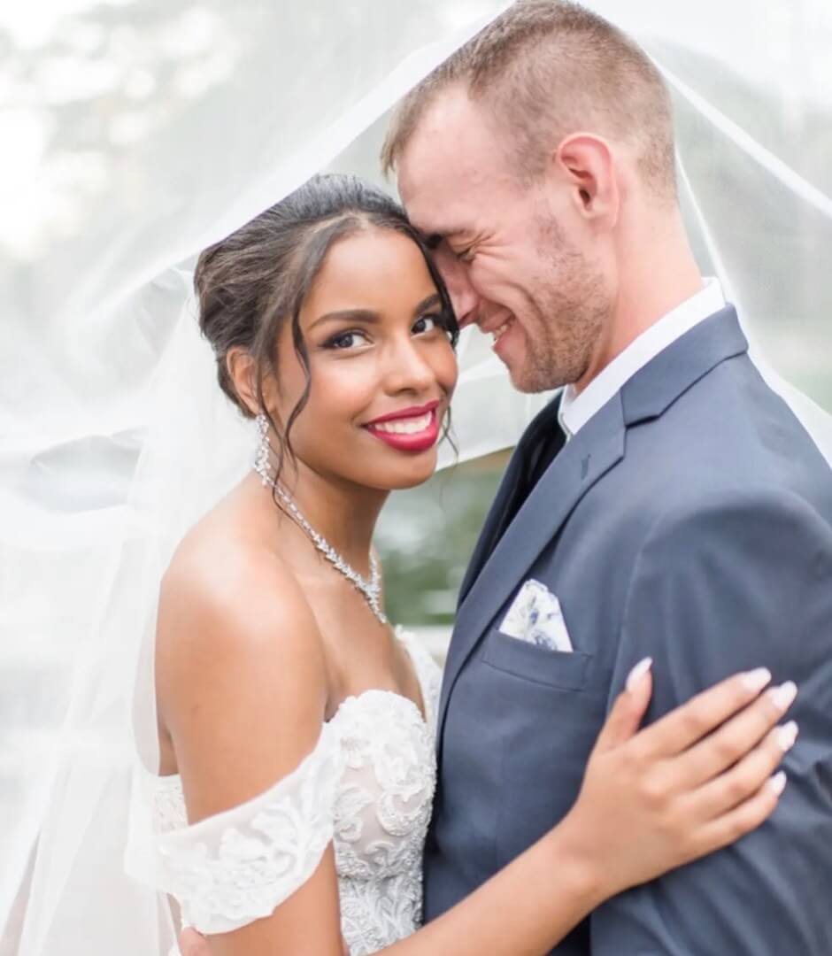 Сouple wearing a white gown and a black suit