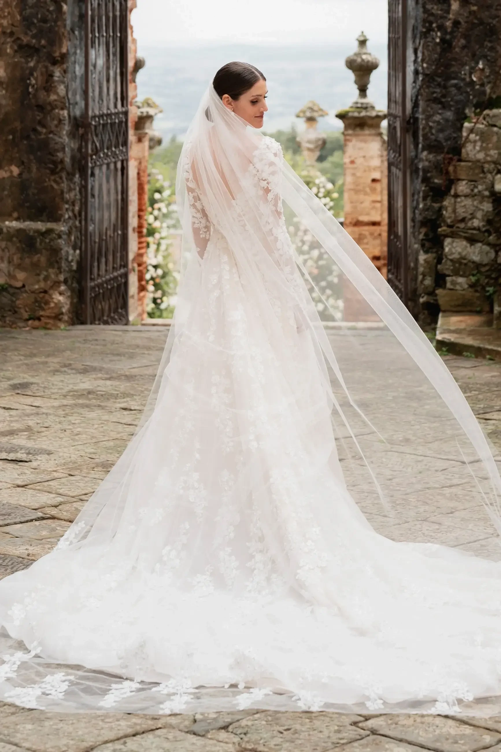 model is wearing a cathedral length bridal veil
