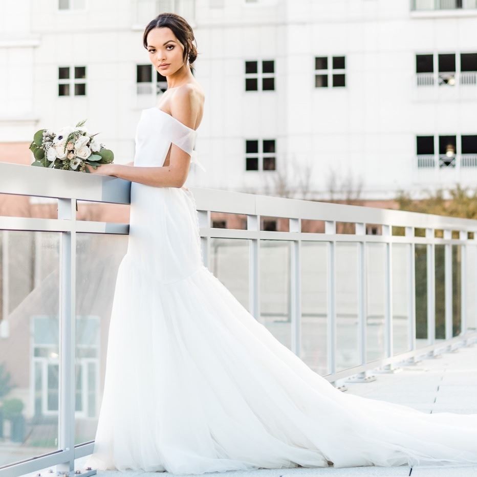 Model wearing white silhouette defining dress
