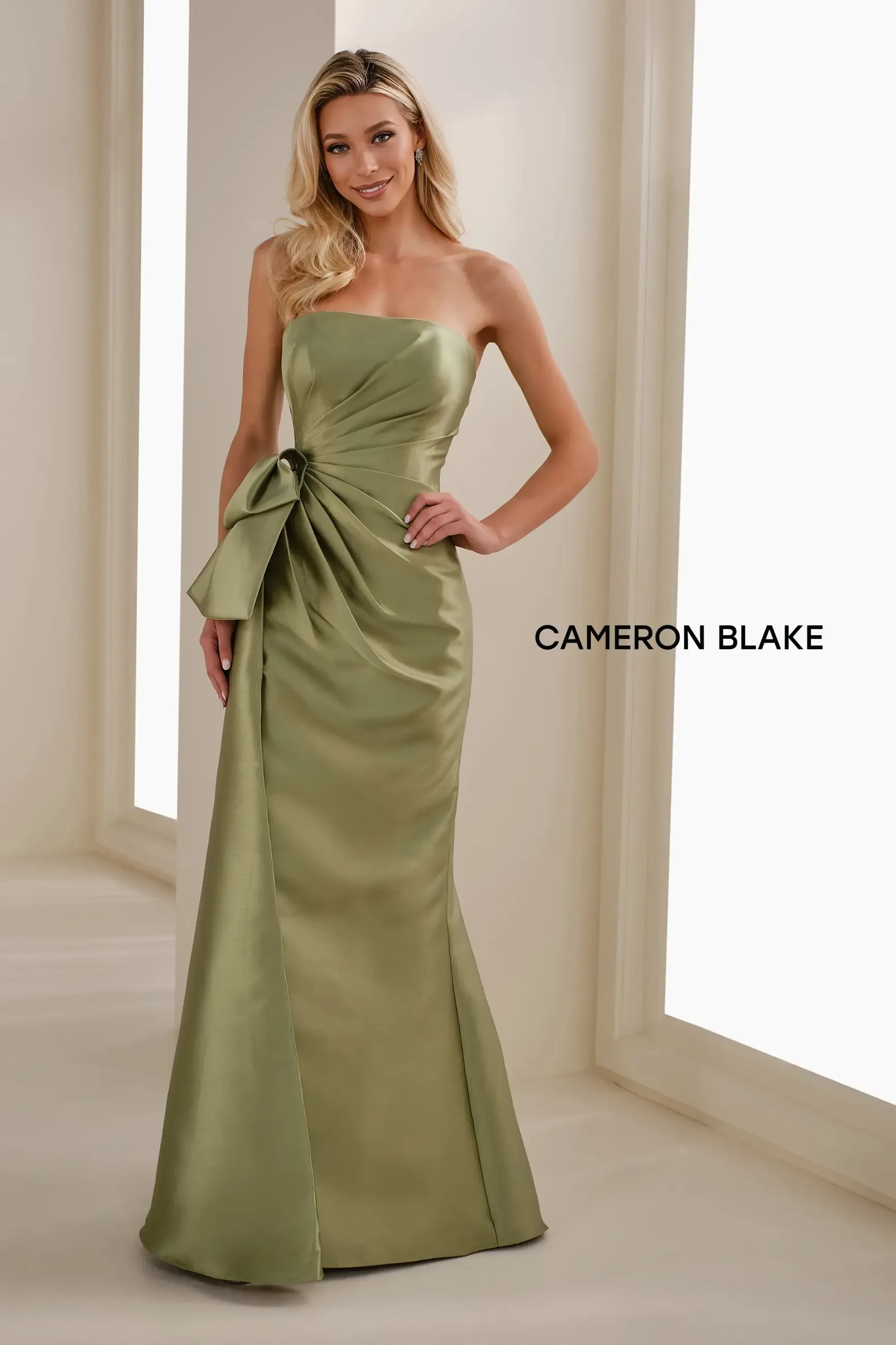 model is wearing a green strapless mother of the bride dress