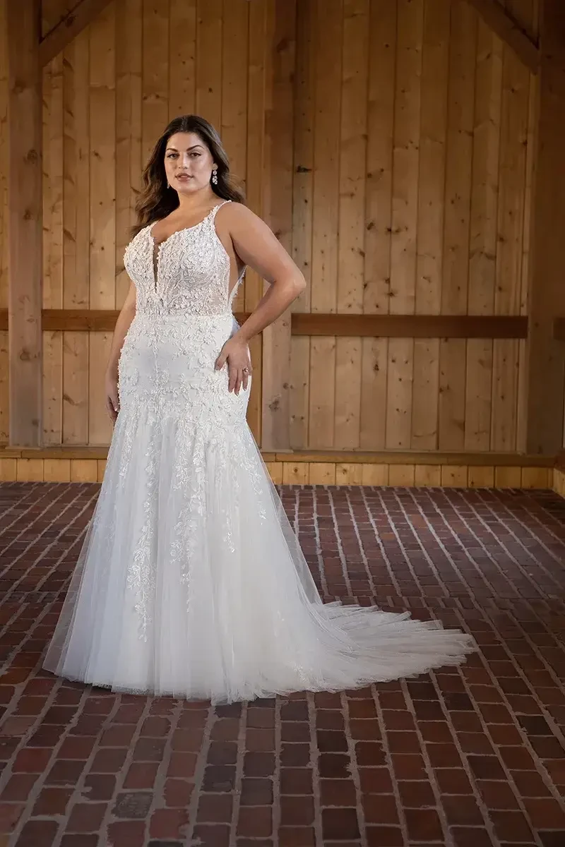 model is wearing a sleeveless trumpet bridal gown