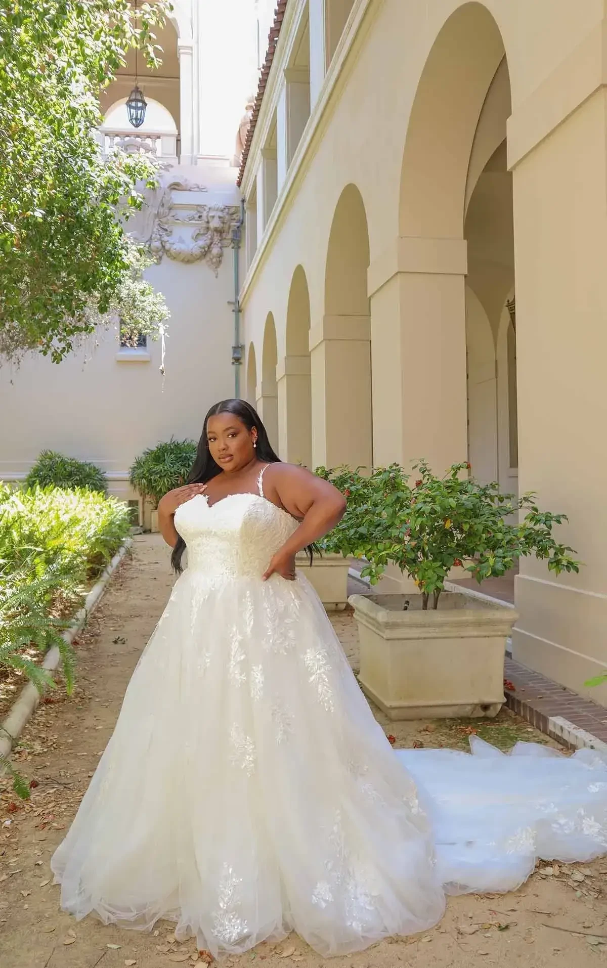 model is wearing a sleeveless ball gown