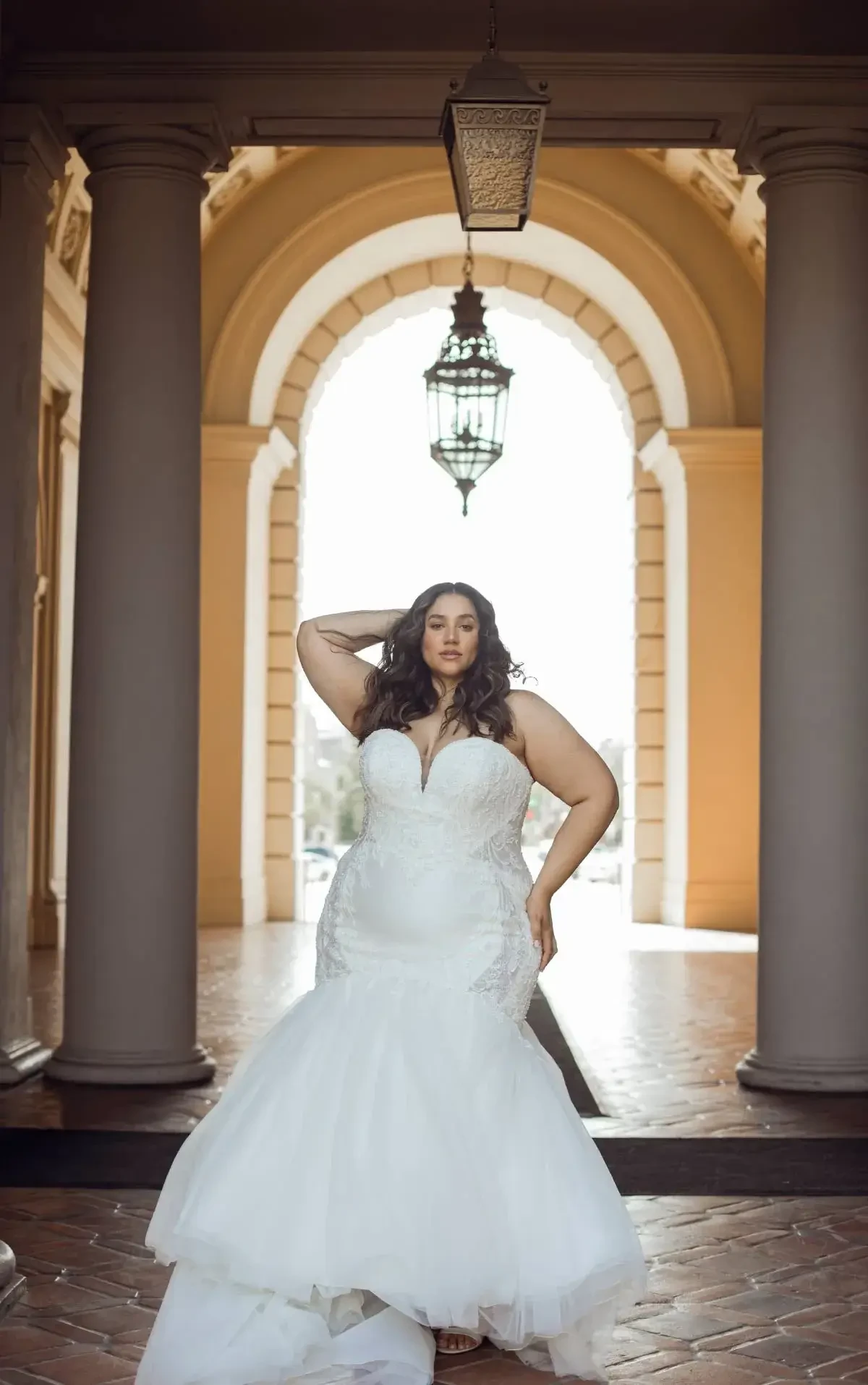 model is wearing a strapless mermaid bridal gown