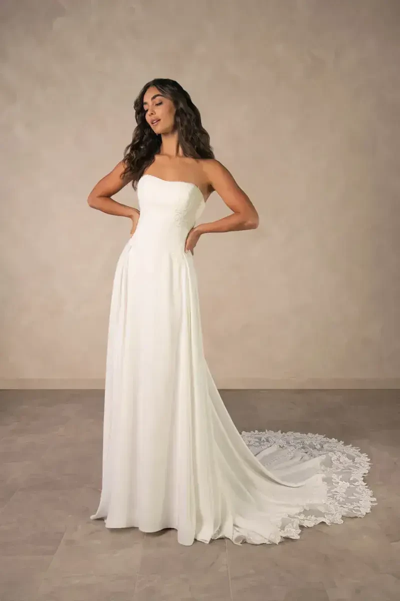 model is wearing a strapless a-line bridal gown