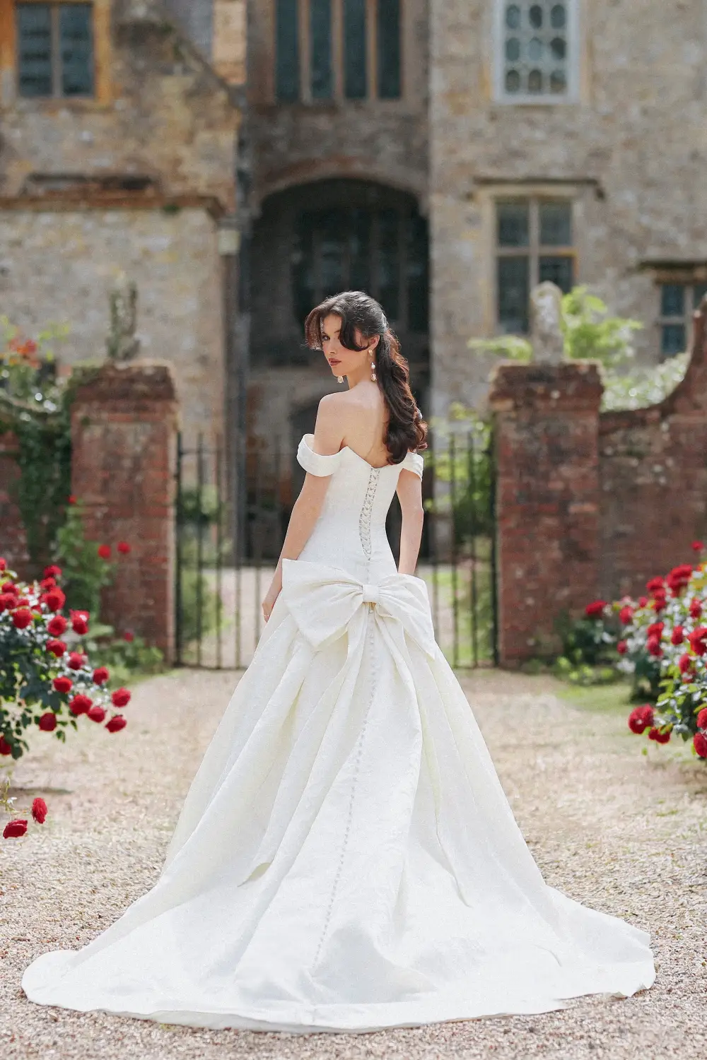 model is wearing a strapless ball gown wedding dress