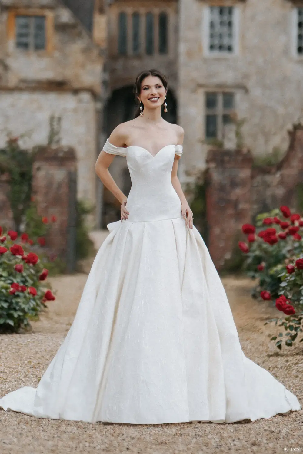 model is wearing a strapless ball gown wedding dress