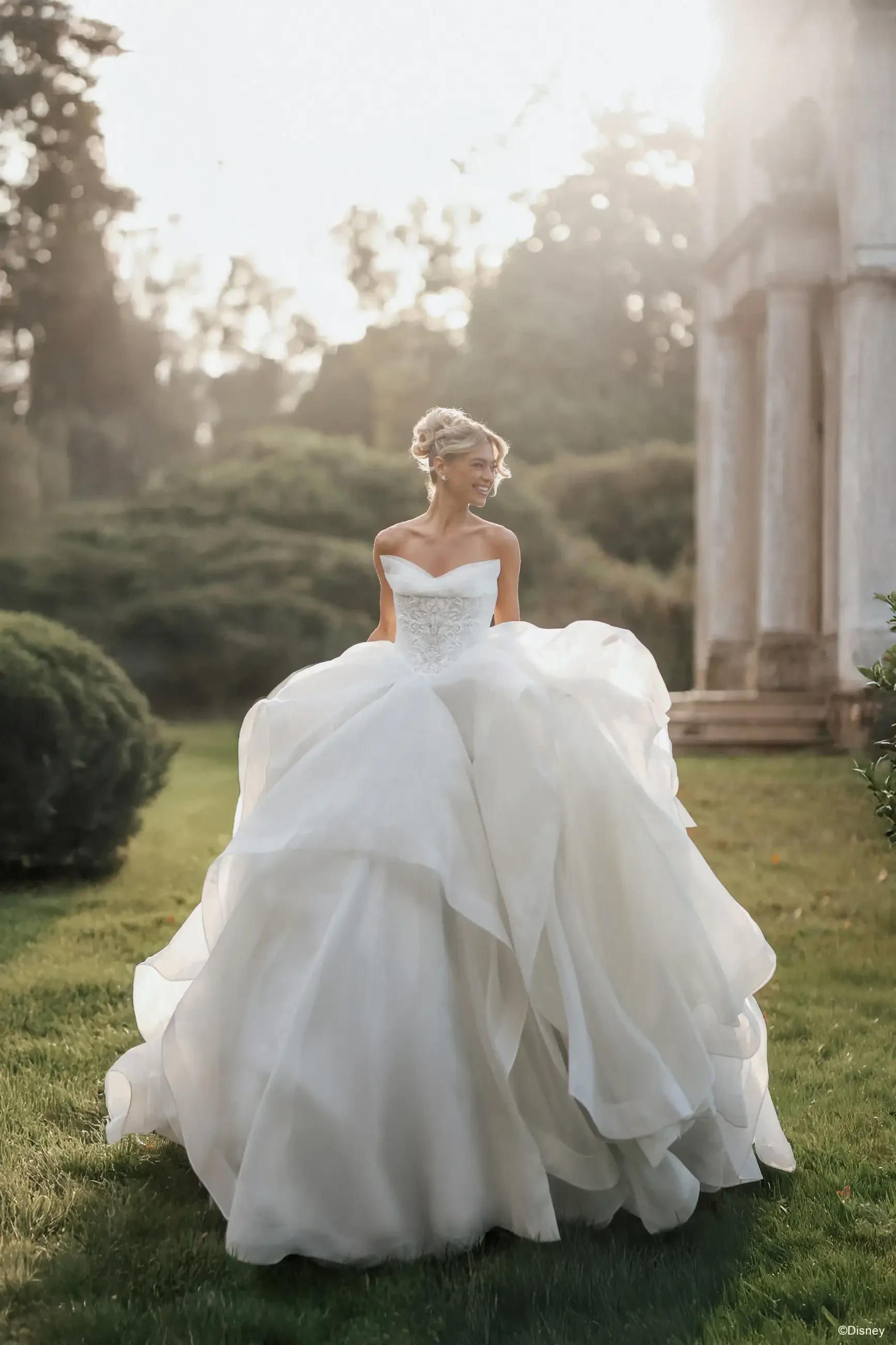 model is wearing a strapless ball gown wedding dress