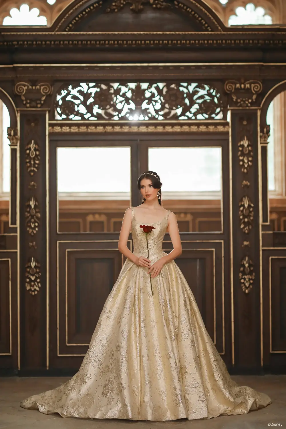 model is wearing a sleeveless gold belle inspired wedding dress