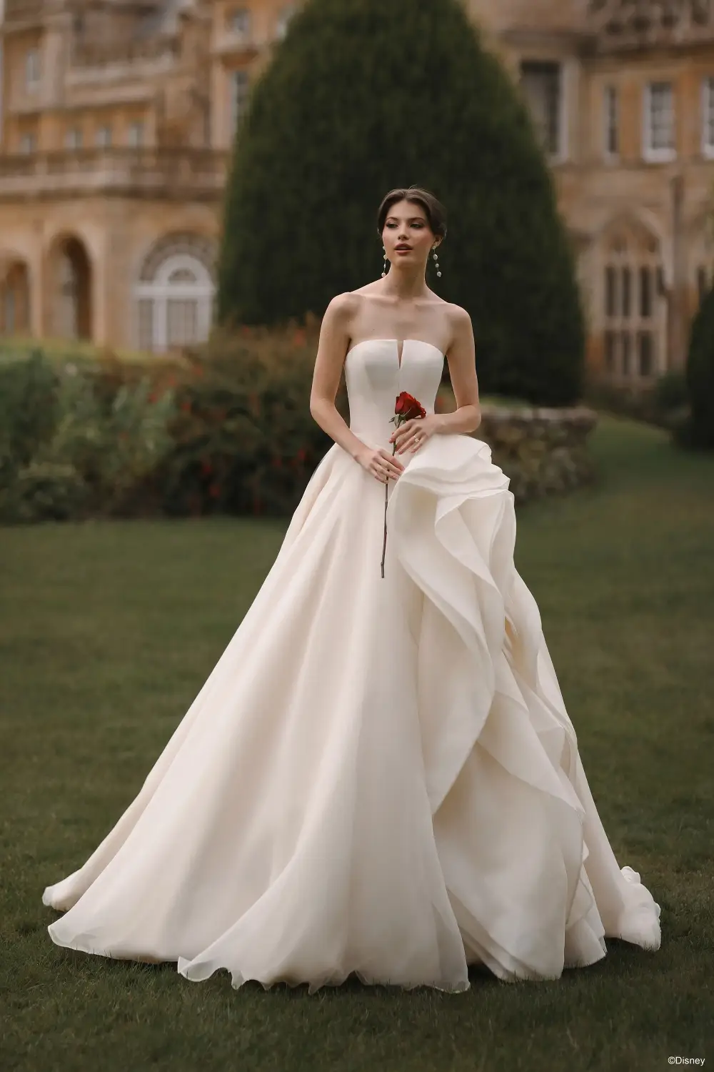 model is wearing a strapless plunging neckline wedding gown 