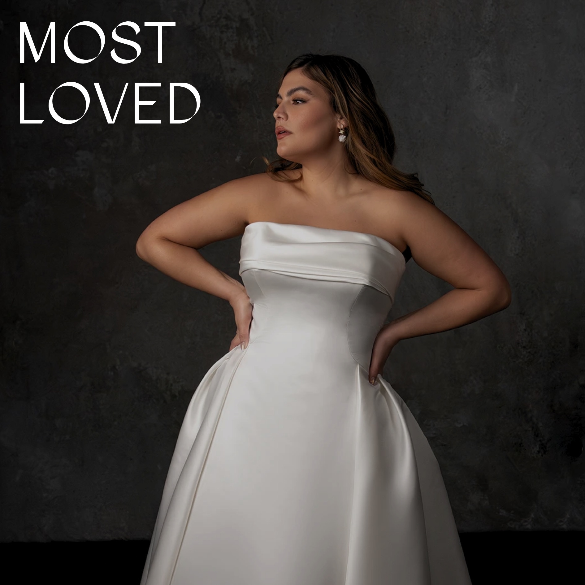 Model wearing white off the shoulder ballgown dress