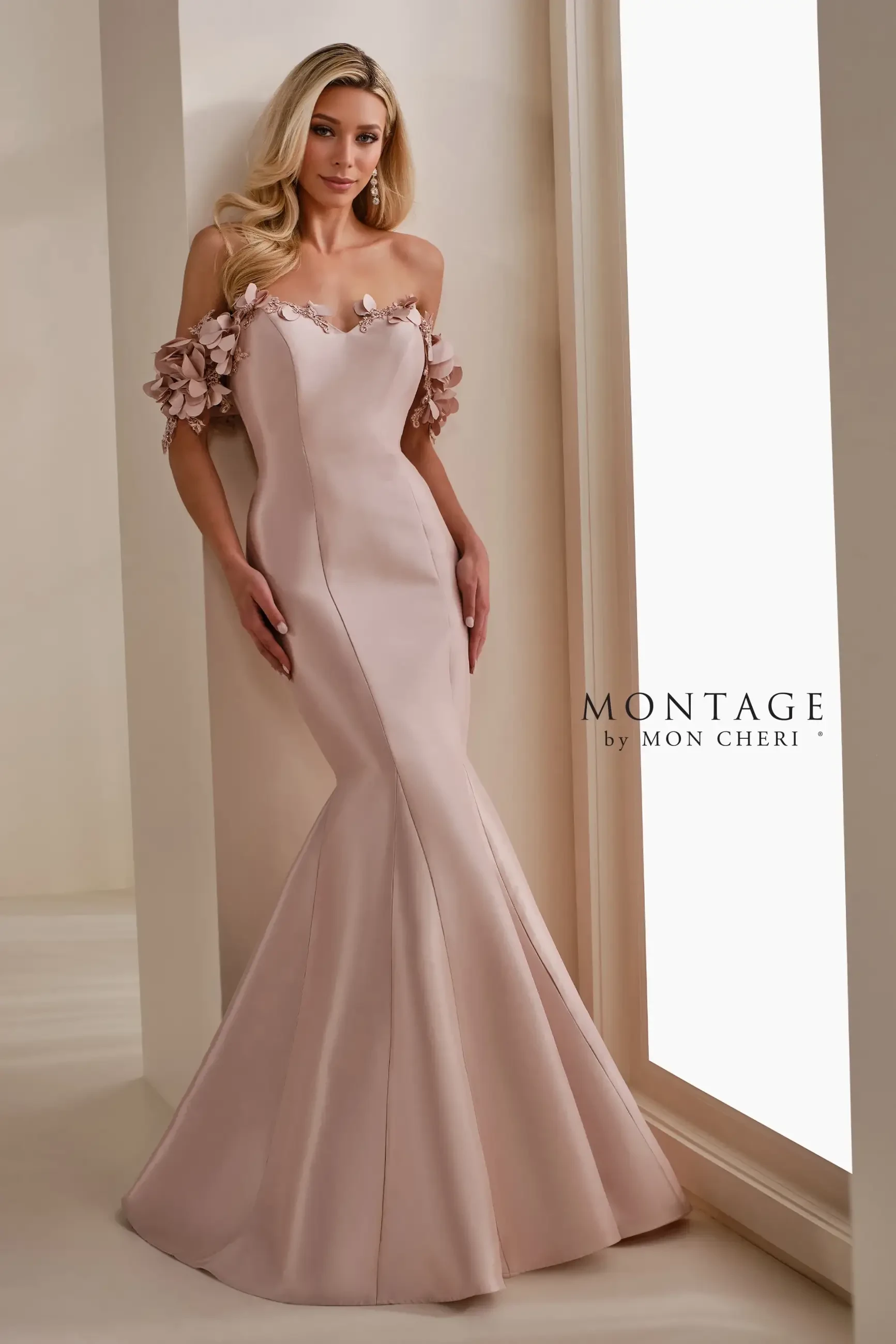 model is wearing a blush colored mother of the bride dress