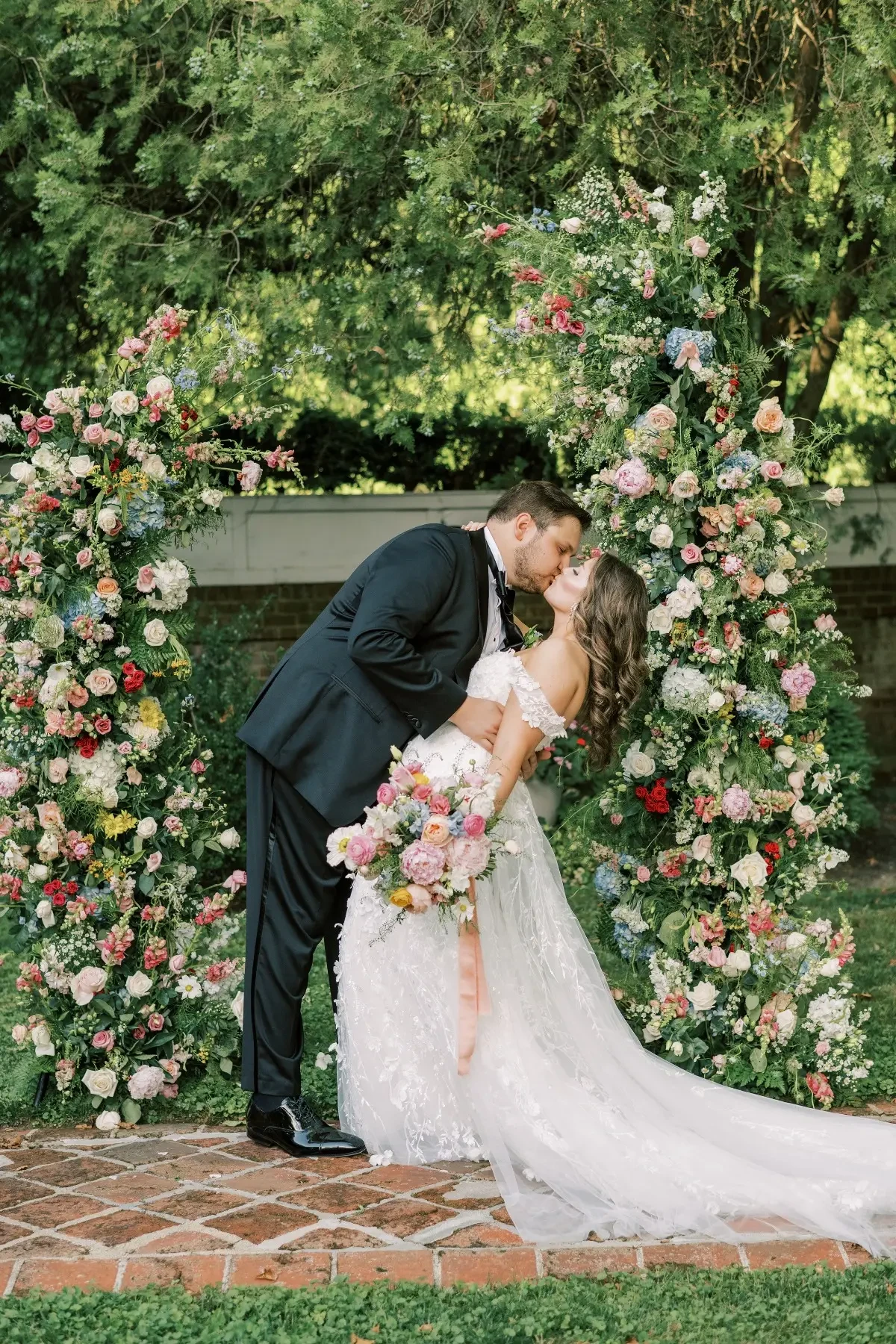 A groom kisses his bride on their wedding day