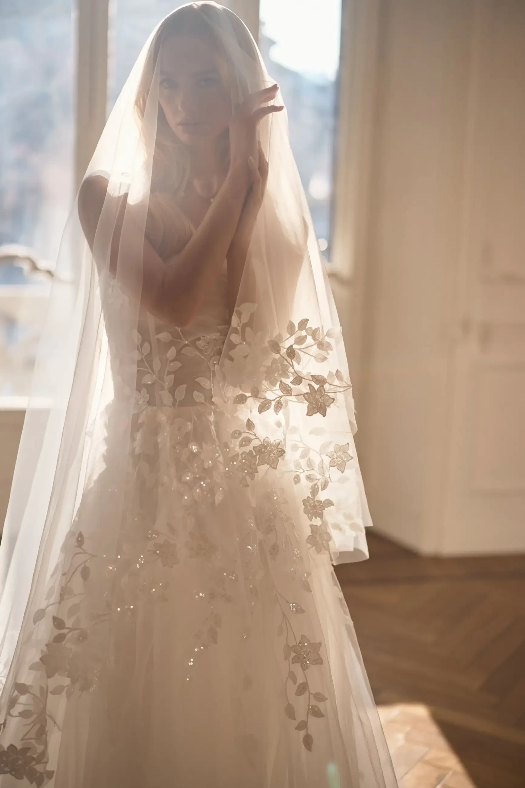 model is wearing a fingertip length bridal veil