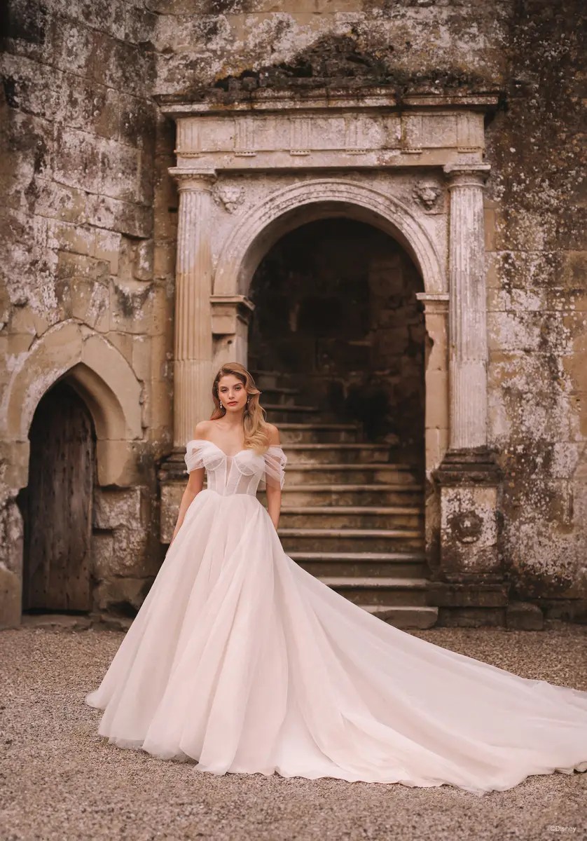 Model wearing a white gown in front of stairs