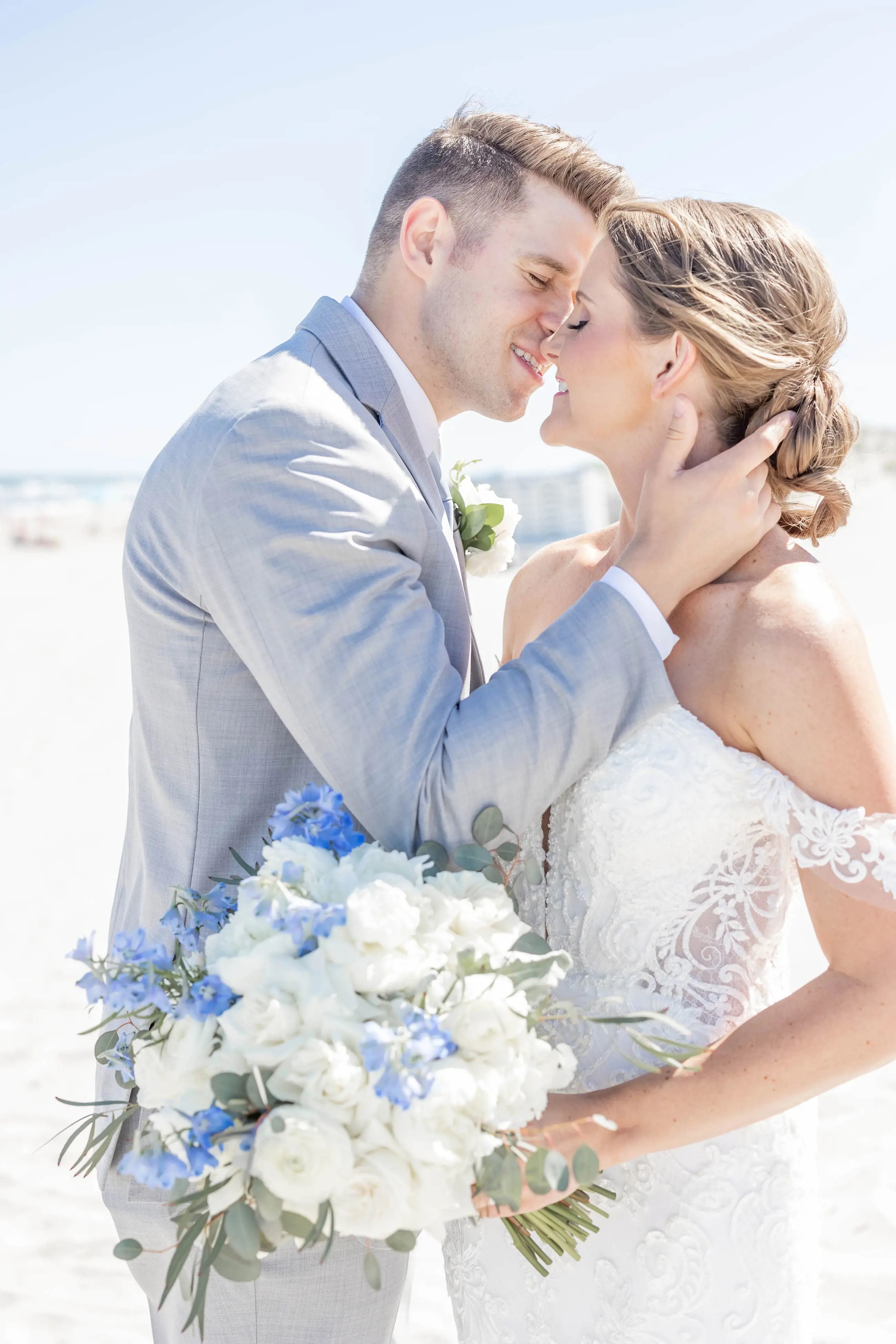 Сouple wearing a white gown and a gray suit