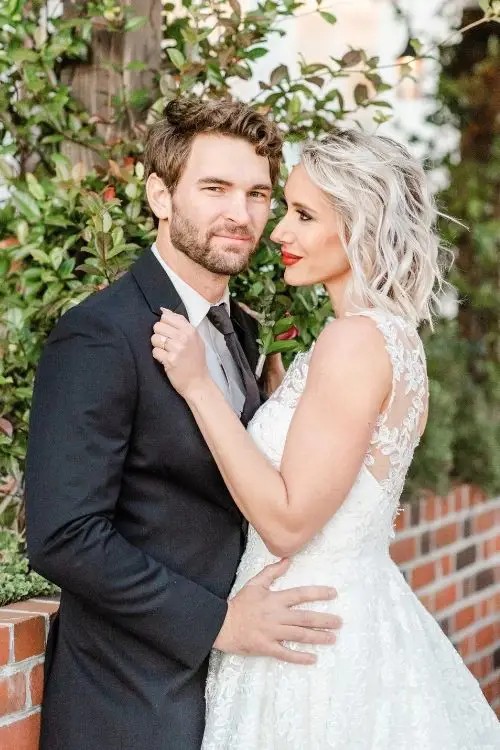 Сouple wearing a white gown and a black suit