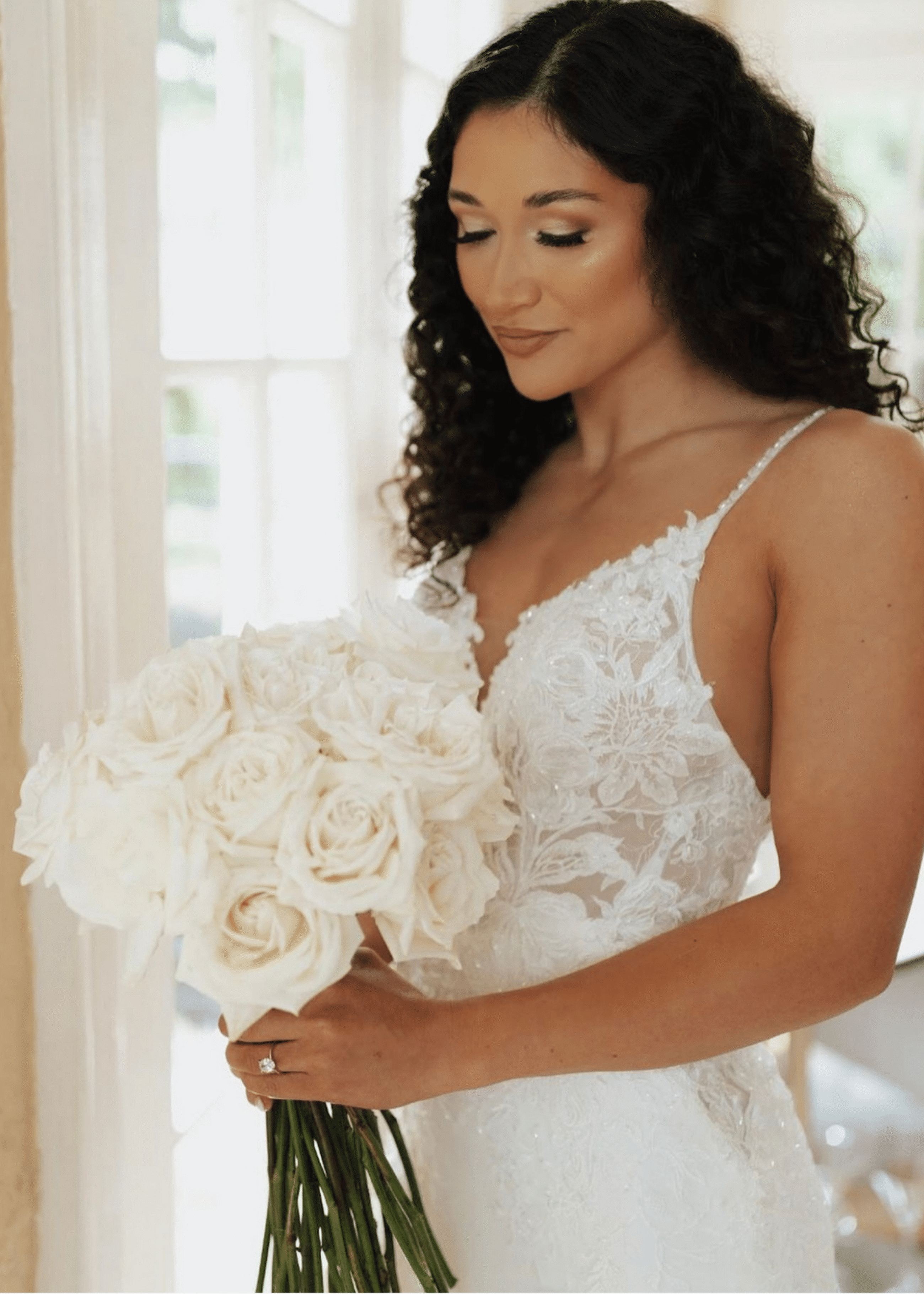 Model wearing a white gown with a flowers