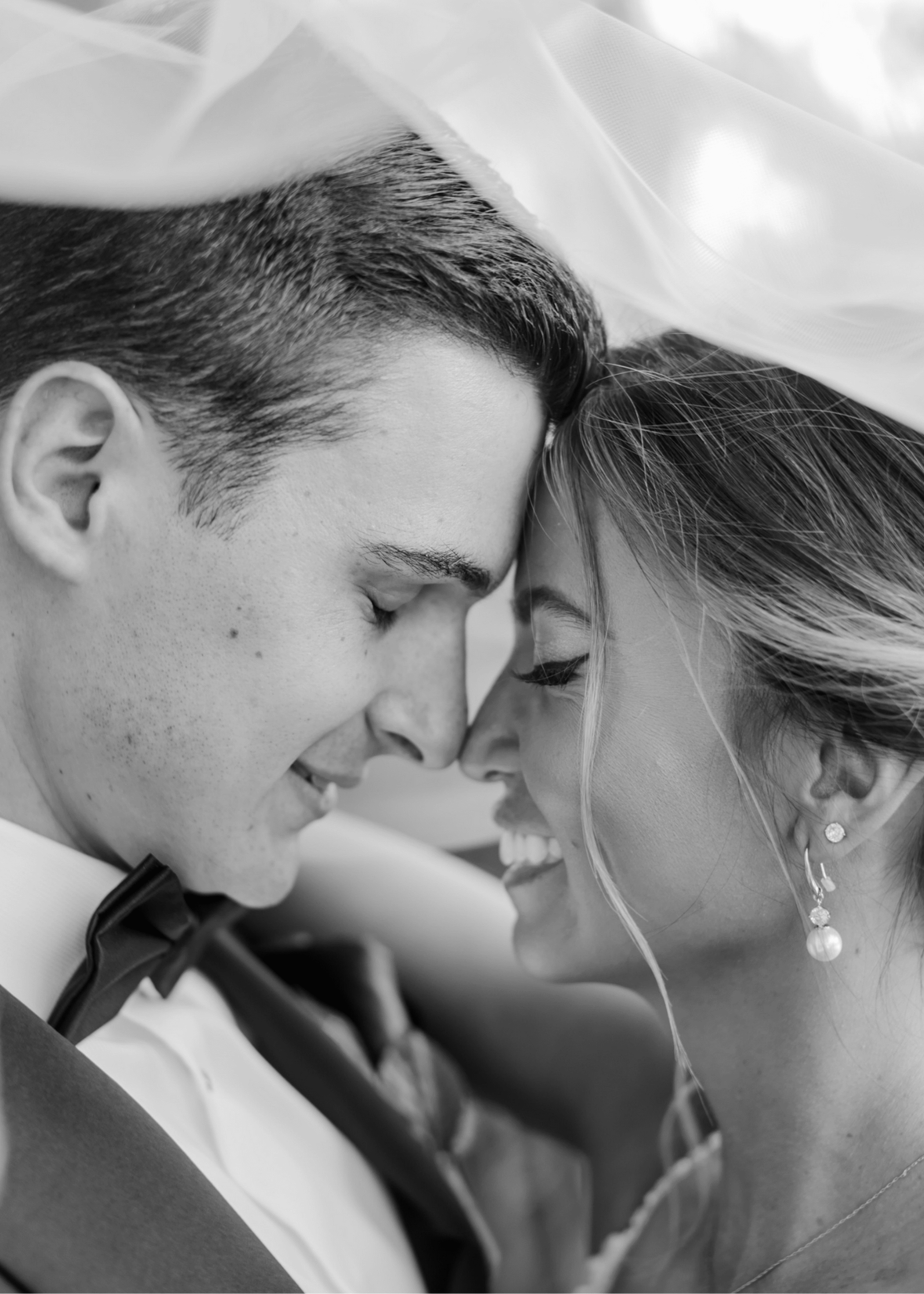 Сouple wearing a white gown and a black suit black and white photo