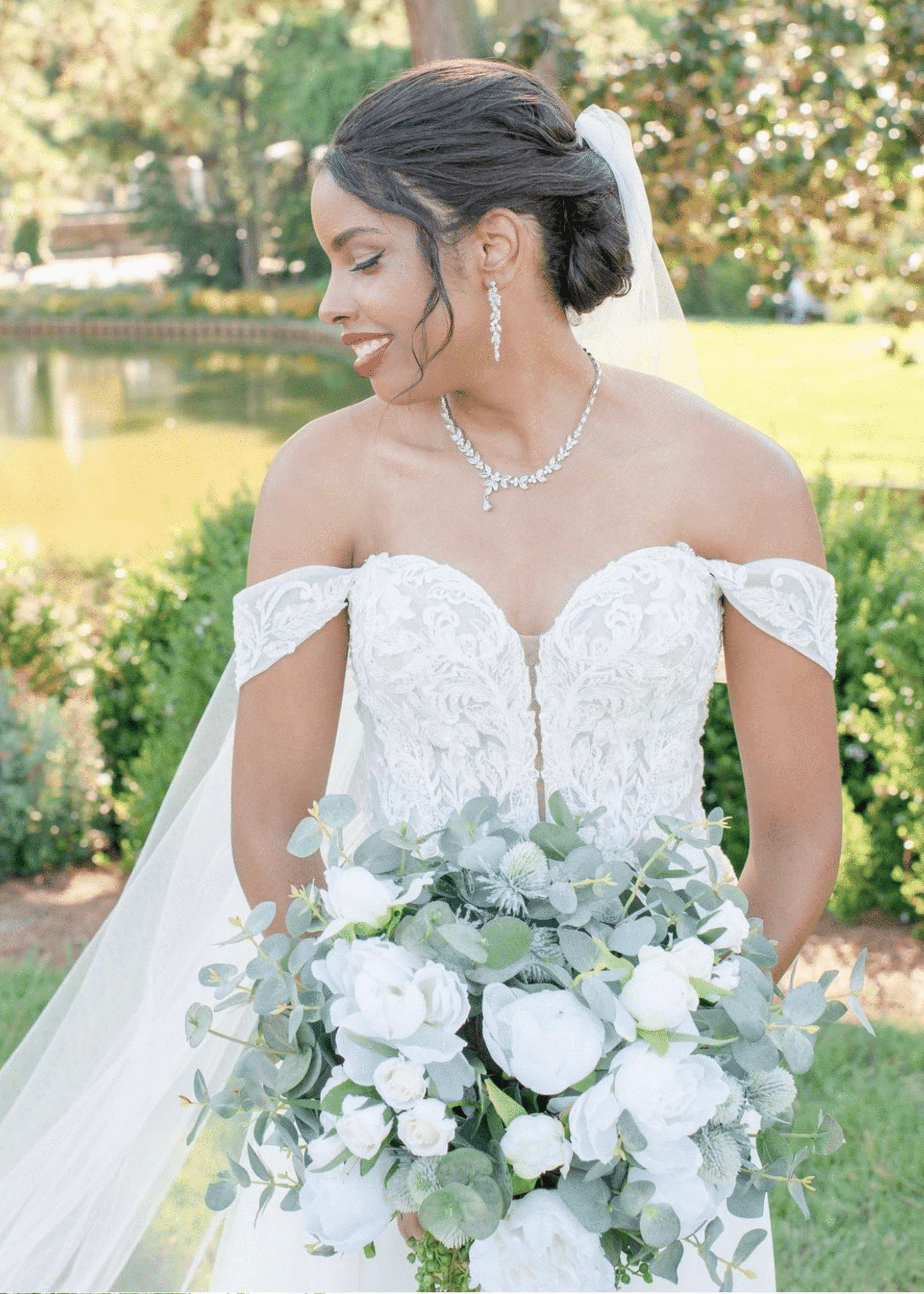 Model wearing a white gown with a flowers