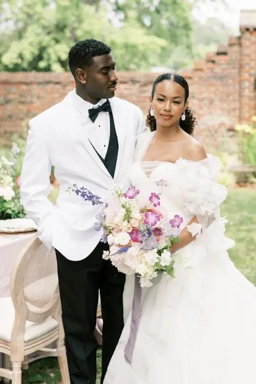 Сouple wearing a white gown and a white suit